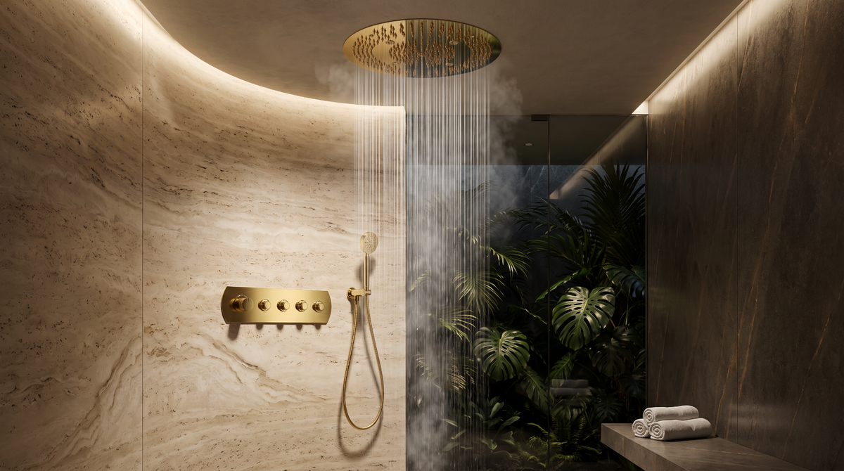 A luxury bathroom or spa shower scene with a round gold rain shower head spraying water, a matching gold handheld shower attachment, warm ambient lighting, marble walls, a glass partition, and tropical plants visible beyond the enclosure.