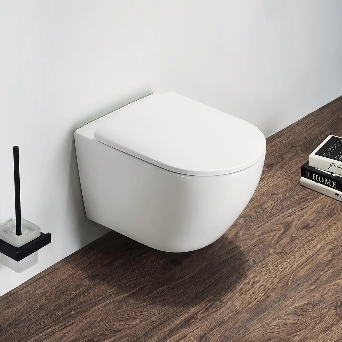 Wall-mounted white toilet in a bathroom with wooden floor and cleaning brush