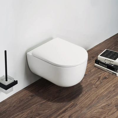 Wall-mounted white toilet in a bathroom with wooden floor and books.