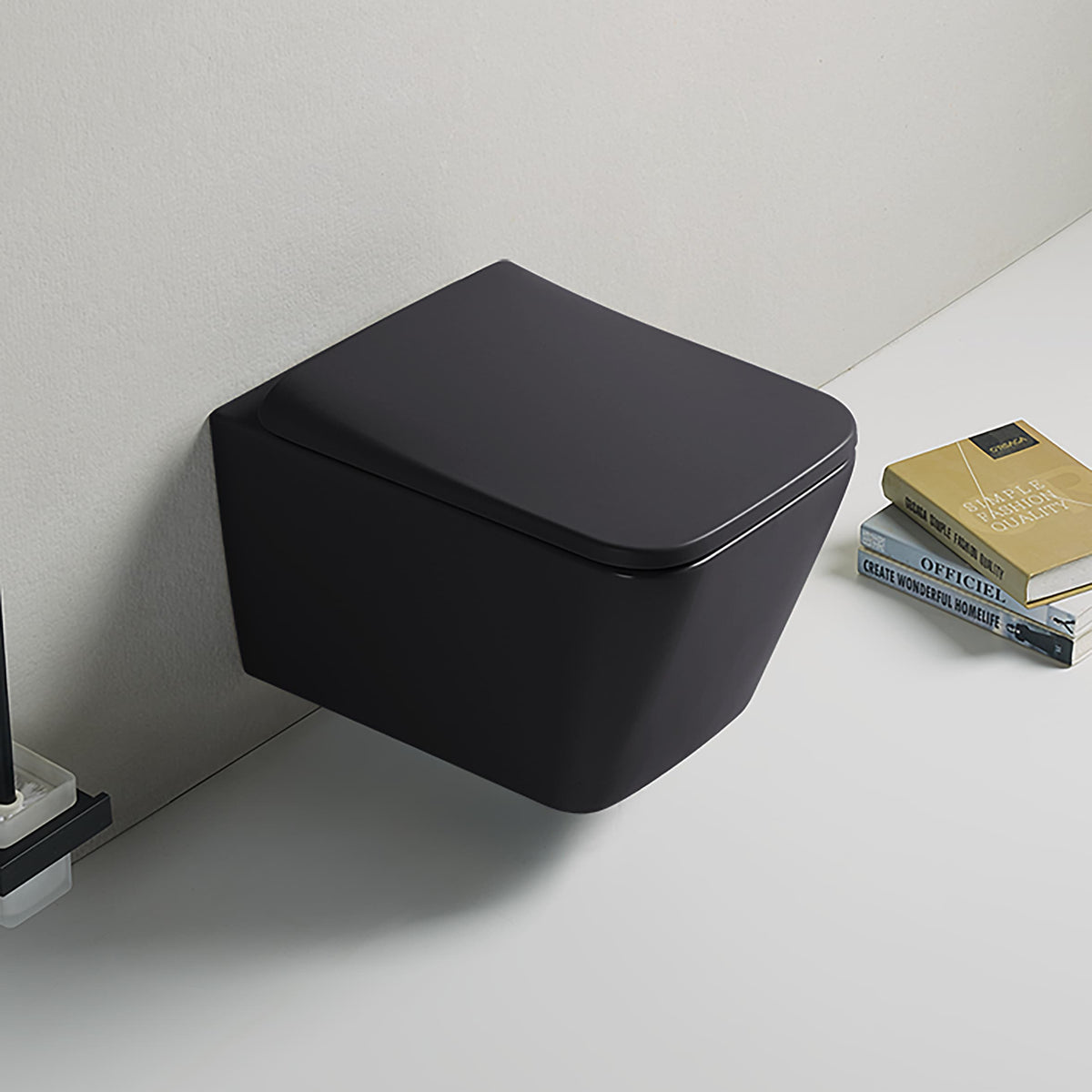 Black wall-mounted toilet with a white floor and books in the background